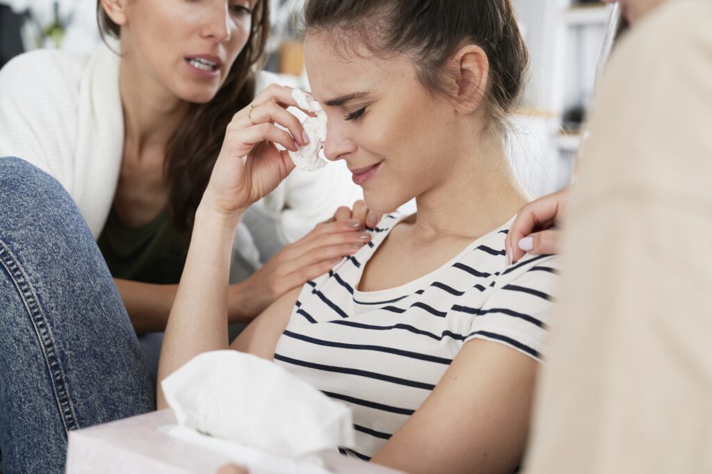 Women comforting a desperate friend